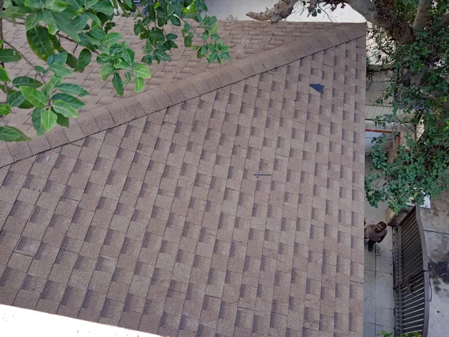 Shingle-clad roof on a fabricated hut structure