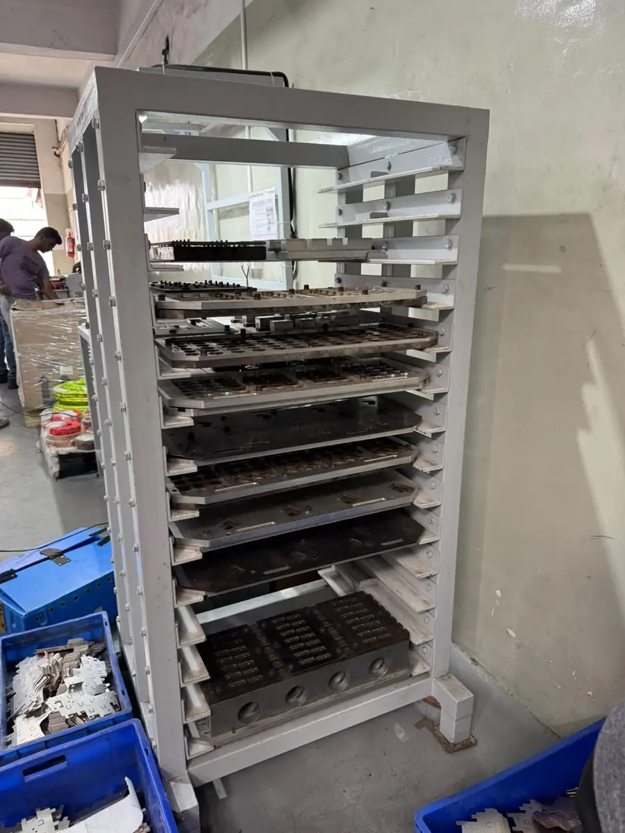 Stainless steel baking tray rack in use on a production floor