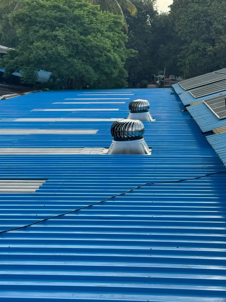 Blue roof sheeting with turbo ventilators on a fabricated shed
