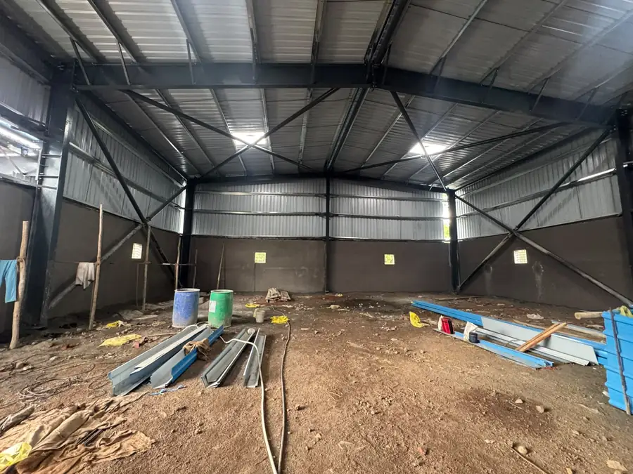 Industrial shed interior during fit-out with steel sections stacked