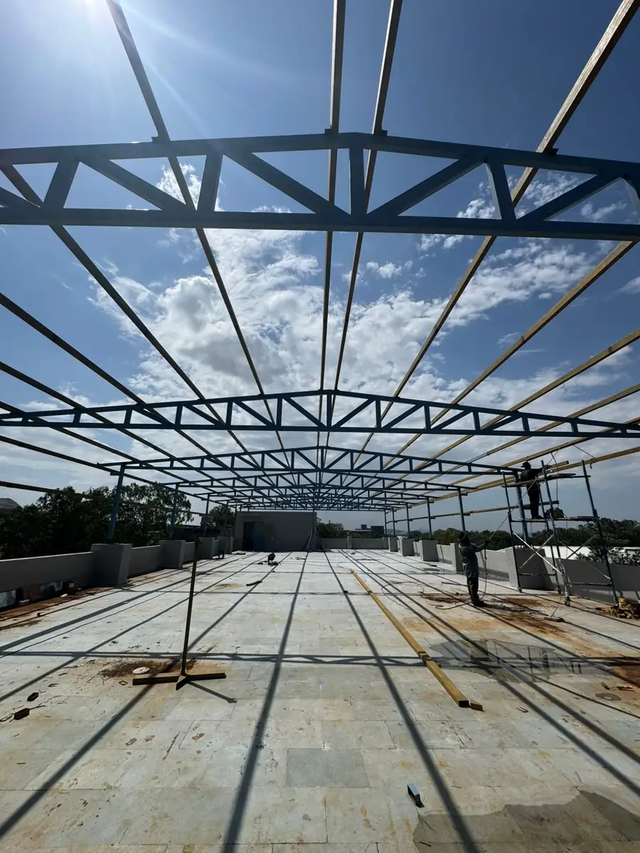 Fabricated shed truss frame silhouetted against the sky