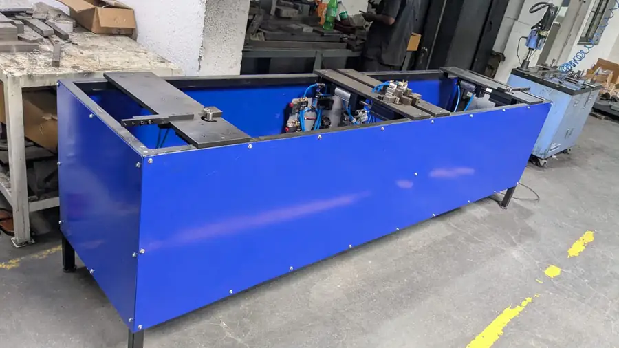 Fabricated tank panel with blue coating on the shop floor